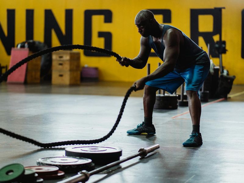 Person performing a dynamic cardio exercise in a gym.